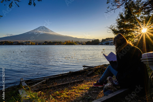 European tourists spend their free time To sit and read on the lake kawaguchiko Japan.