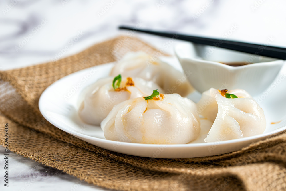 Crystal dumplings with minced pork filing, garnished with green onion and fried shallot Crystal dumplings with minced pork filing, garnished with green onion and fried shallot