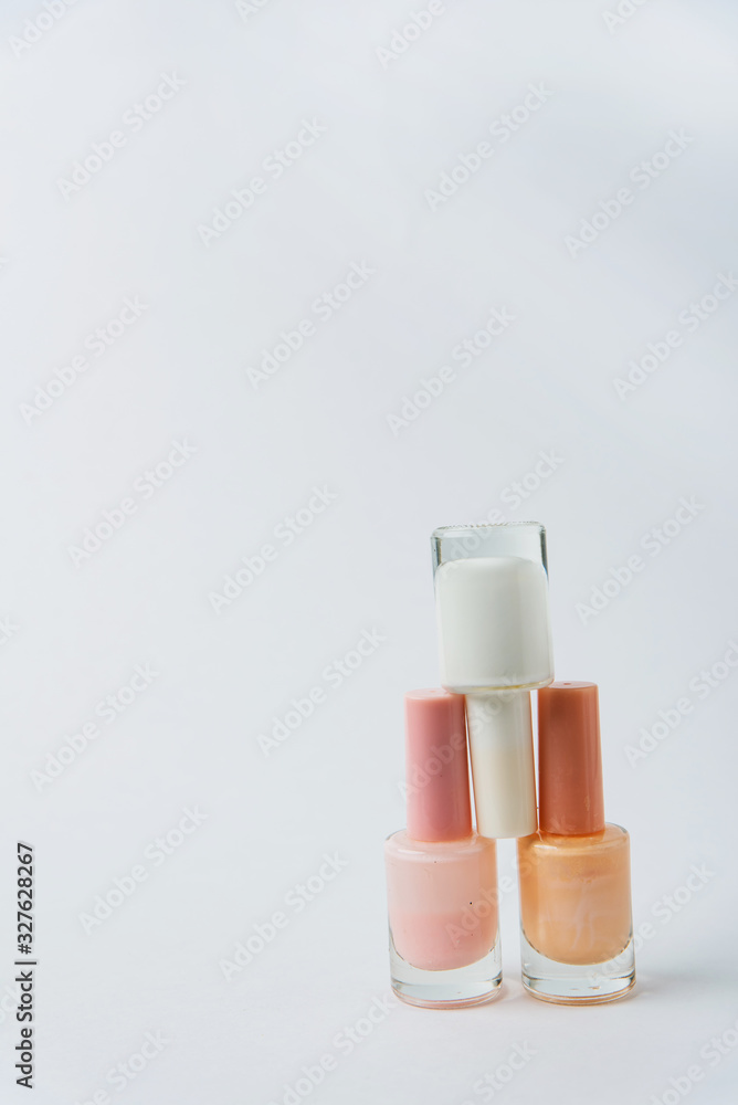 colored nail polishes on a white background colored nail polishes on a white background
