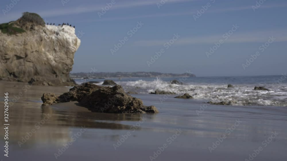 Waves rolling over a few rocks on a beach off the coast of California. Waves rolling over a few rocks on a beach off the coast of California.