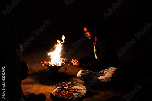 Saharaui man doing barbecue with fire photo