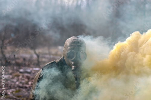 Soldier in gas mask getting smoked by a smoke canister