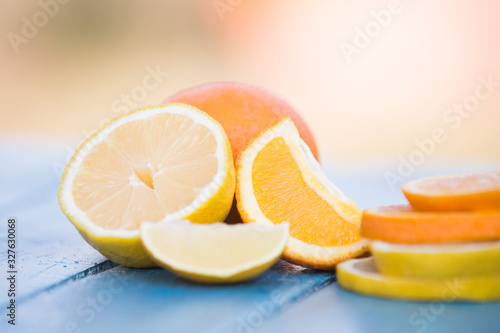 Orange and lemon slices on wooden background