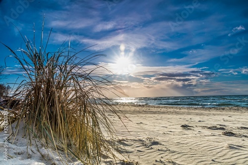 colored sunset at the beach - beautiful sunset on the baltic sea with blue sky © Riko Best