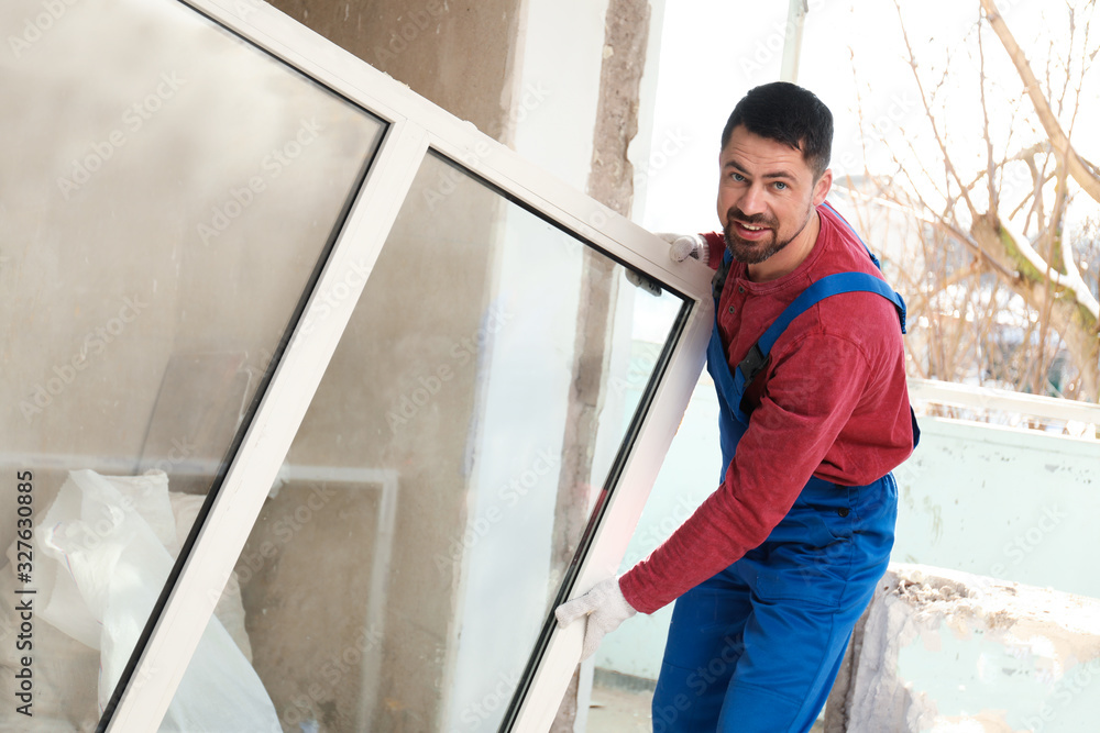 Worker in uniform with plastic window indoors