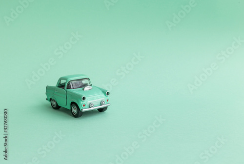 Mint toy car on  the road on a neo mint background