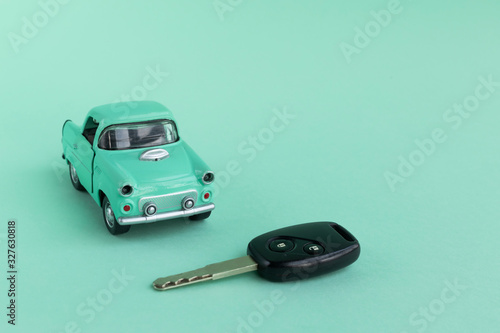 Toy car with key  on a menthol background  