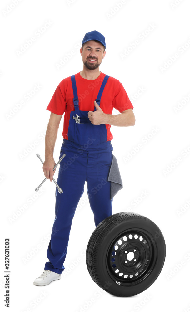 Full length portrait of professional auto mechanic with lug wrench and wheel on white background Full length portrait of professional auto mechanic with lug wrench and wheel on white background