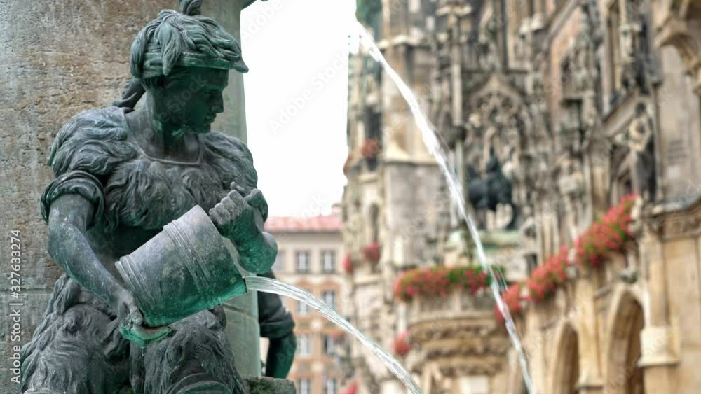 Locked down real time medium shot of the Figure of a boy on the famous fish fountain on the Marienplatz in Munich, November 27, 2019 in Munich, Germany. Locked down real time medium shot of the Figure of a boy on the famous fish fountain on the Marienplatz in Munich, November 27, 2019 in Munich, Germany.