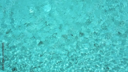 Beautiful blue or turquoise water in the pool overlooking the sea and landscape. An expensive and luxurious white villa with a blue pool. Travel and high. Interior