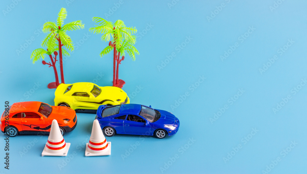 Small toy cars. Miniature children’s models of cars on a blue background. Copy space for text
