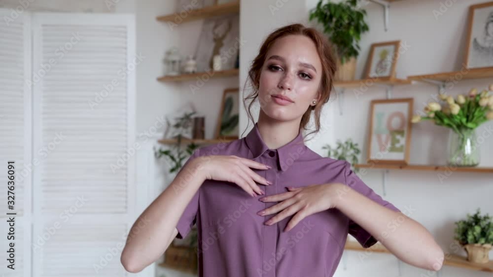 Beautiful girl with red hair in a blouse posing, smiling in a beautiful interior, 50 fps Beautiful girl with red hair in a blouse posing, smiling in a beautiful interior, 50 fps