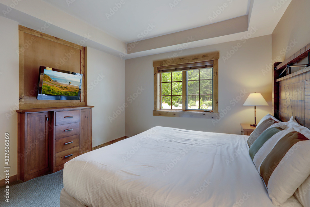 Cozy small luxury vacation home bedroom with white linen on wooden large bed Cozy small luxury vacation home bedroom with white linen on wooden large bed