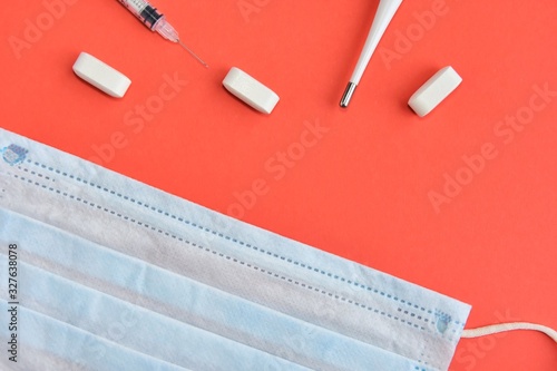 Pills  syringe  thermometer and protection mask on neutral background. Seasonal disease concept. Set for cold and flu treatment. 