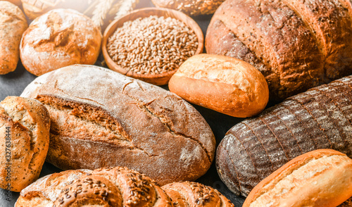 Various kind of bread with wheat top view. White bakery food concept panorama or wide banner photo.