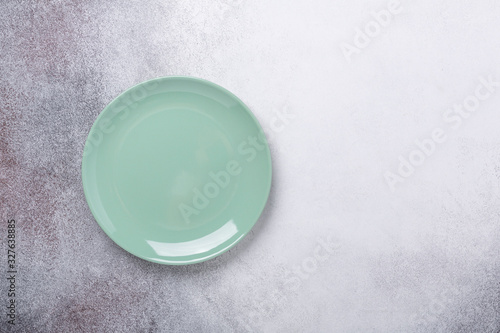 Empty mint plate on stone background. Copy space. Top view
