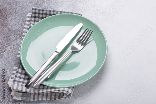 Mint plate and cutlery on stone background