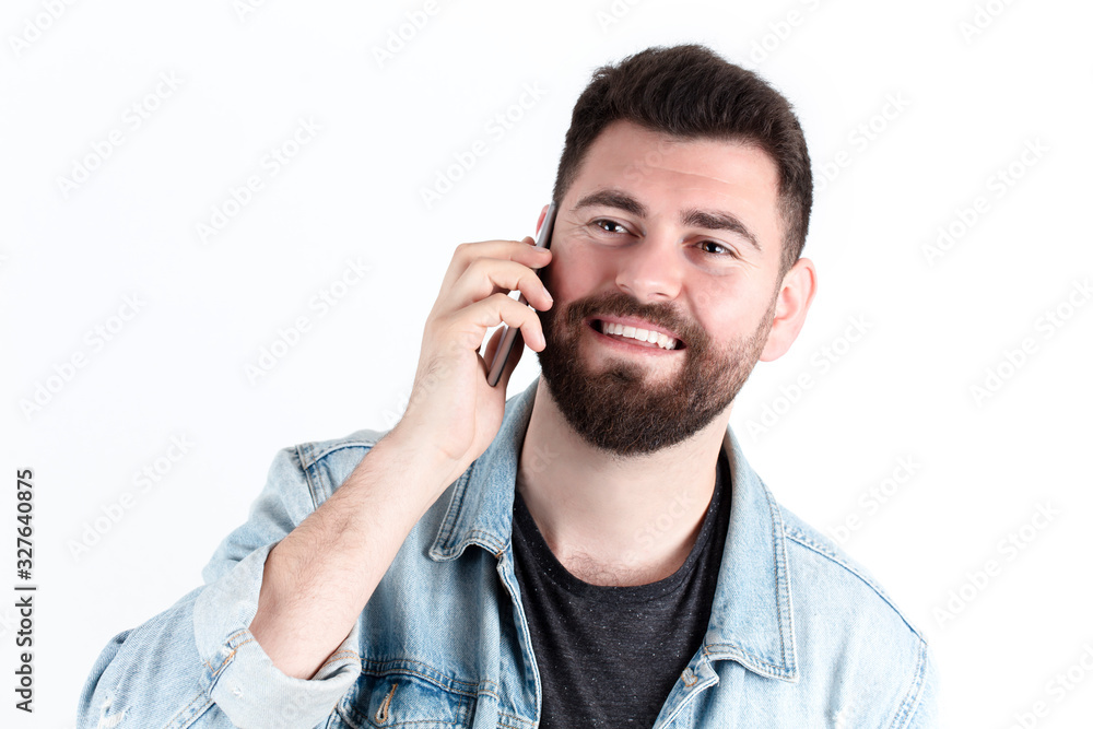 Young and handsome man speaking by smart phone over white background. Young and handsome man speaking by smart phone over white background.