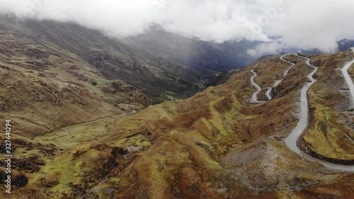 Curvy road in mountains of Peru.  Cusco region. Foggy serpentine on high altitude photo