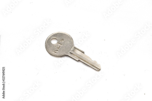 A silver padlock key, close up, isolated on a clean, white background.  Shot in macro. © Peter
