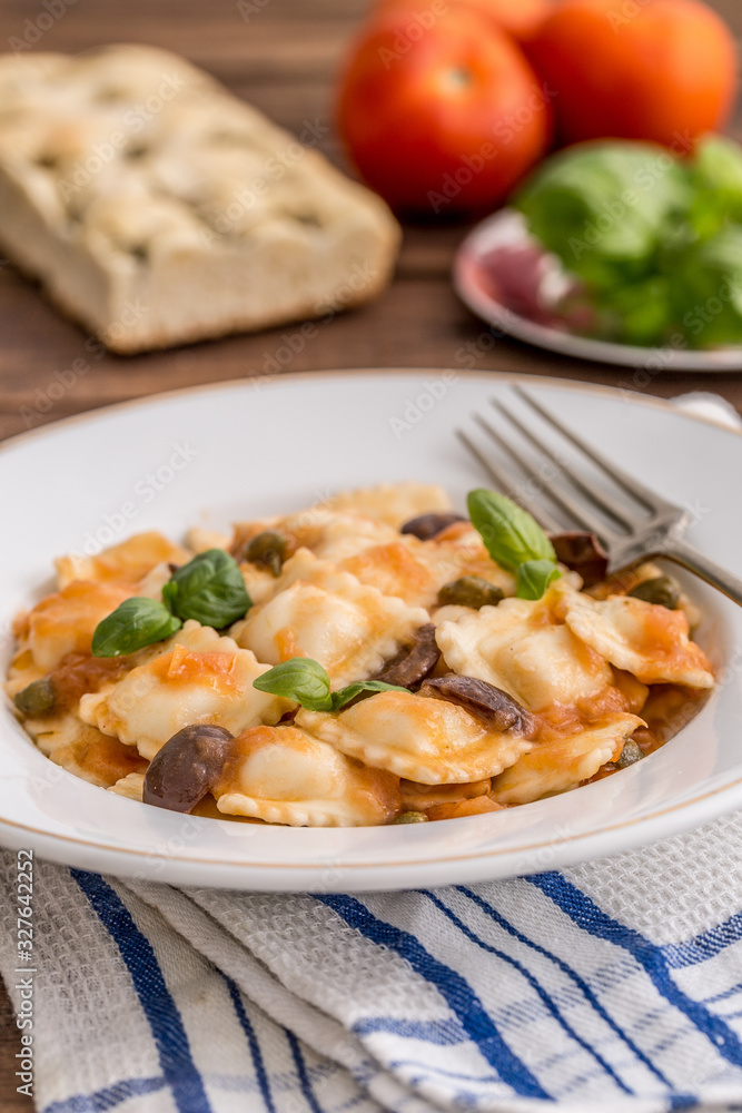 Vegetable ravioli with caper tomatoes and black olives Vegetable ravioli with caper tomatoes and black olives