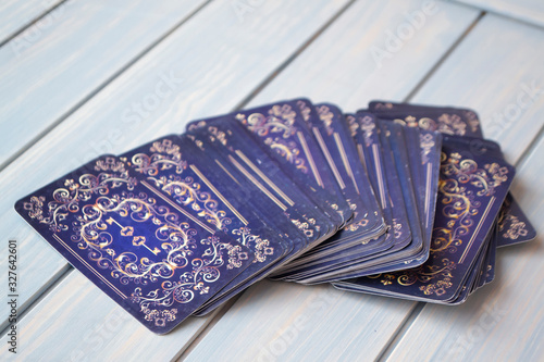 Vintage tarot cards deck on wooden blue table.