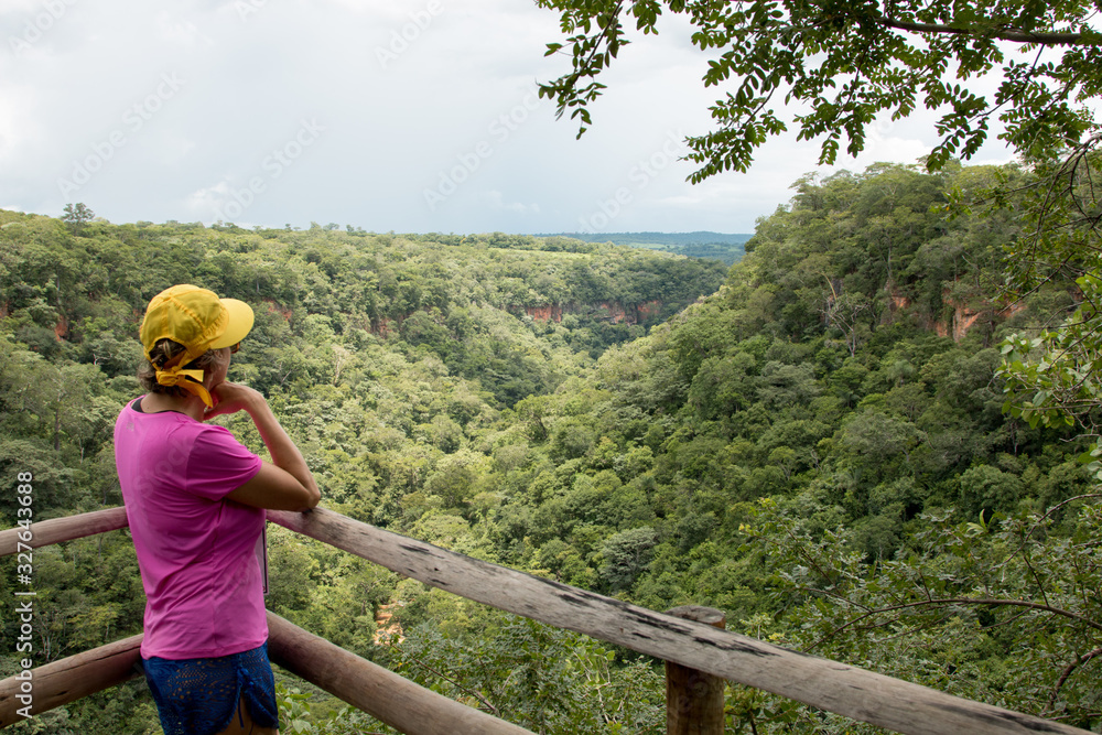 Woman Standing and Looking out over the Landscape at the Lookout Point near the Lapa Cave or Caverna Lapa do Penhasco in Mambai, Goias, Brazil 