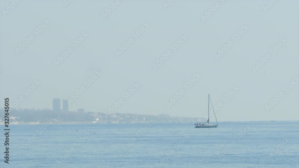 Sailboat on sea facing coast of Marbella. Tracking slow motion Sailboat on sea facing coast of Marbella. Tracking slow motion