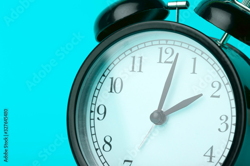 Time background concept. Vintage classic alarm clock on blue empty background. Time management concept