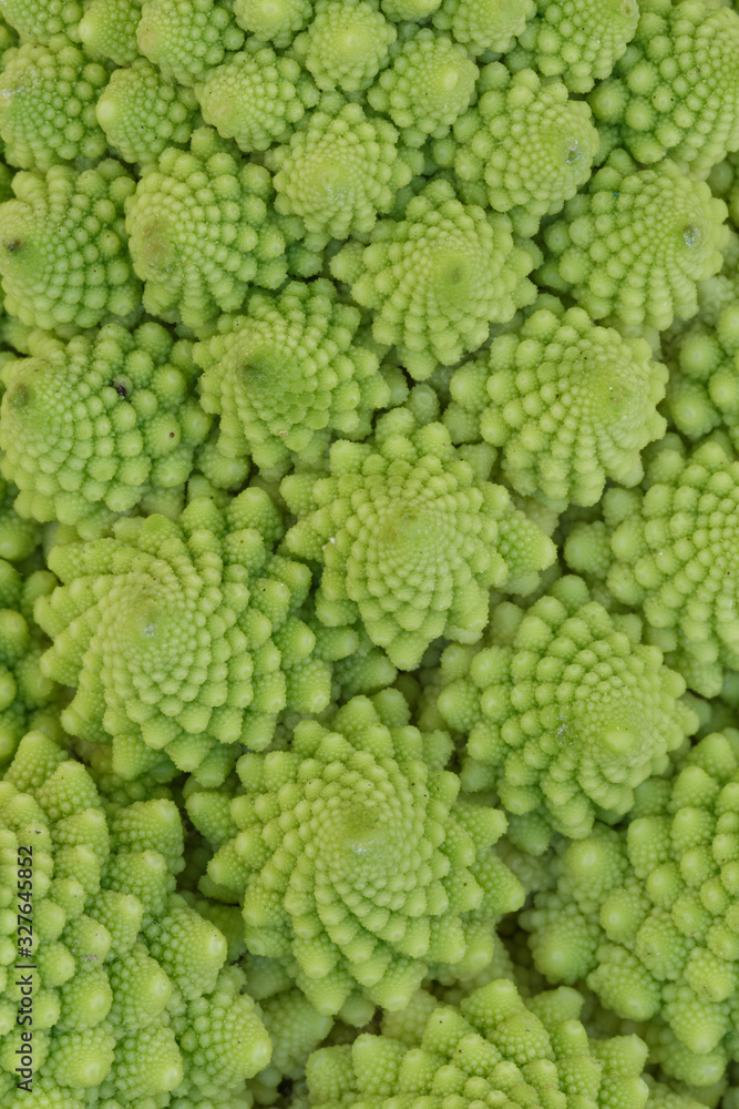Close-up of natural fractals of Romanesco broccoli (also known as Roman cauliflower, Broccolo Romanesco, Romanesque cauliflower or simply Romanesco). Viewed from above, abstract full frame photo. Close-up of natural fractals of Romanesco broccoli (also known as Roman cauliflower, Broccolo Romanesco, Romanesque cauliflower or simply Romanesco). Viewed from above, abstract full frame photo.