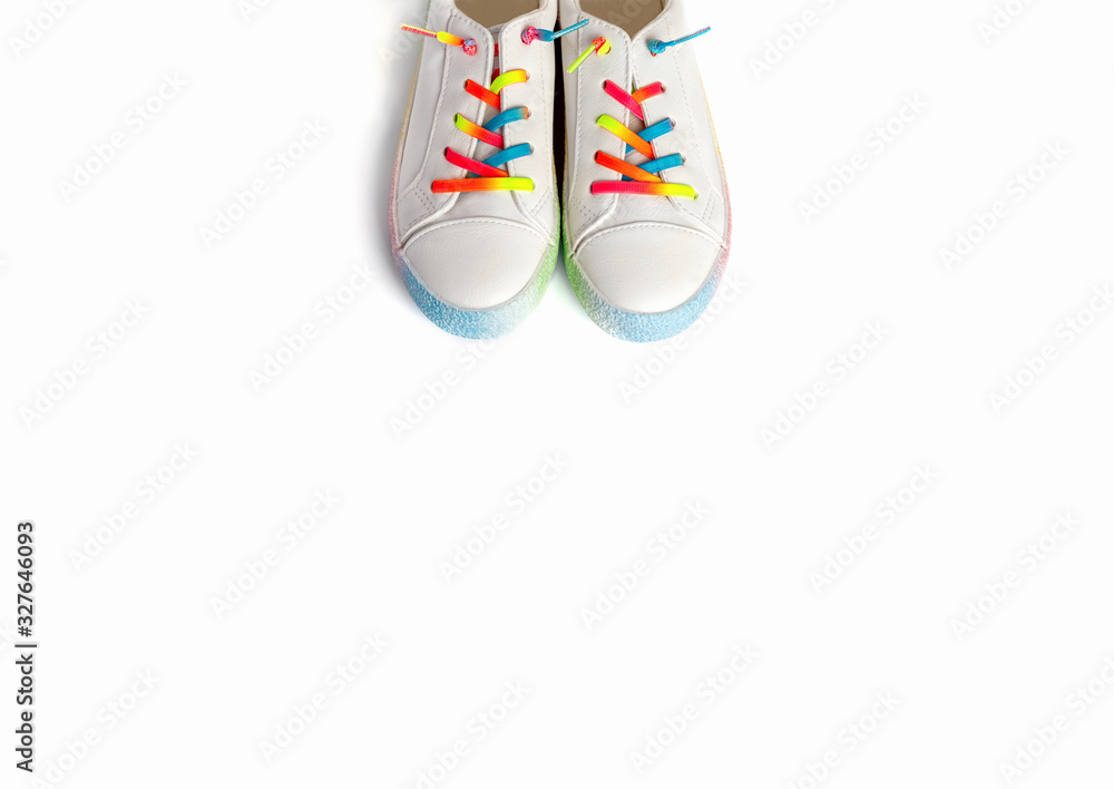 Close up running shoes with rainbow laces for the child on a isolated backgroun. Top view.