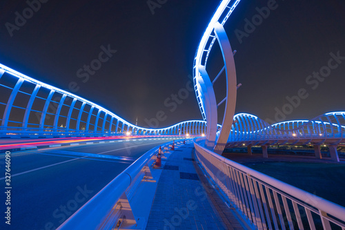 Photography Meydan Bridge and street road or path way on highway with modern architecture buildings in Dubai Downtown at night, urban city at night, United Arab Emirates or UAE