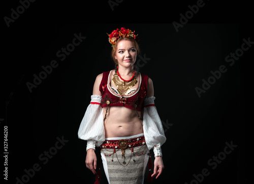 Canvas Print beautiful dancer in traditional folk white with red slavic costume with wreath,