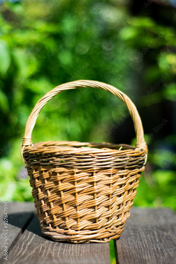 closeup of pea pods in a wicker basket on wooden table on green trees background closeup of pea pods in a wicker basket on wooden table on green trees background