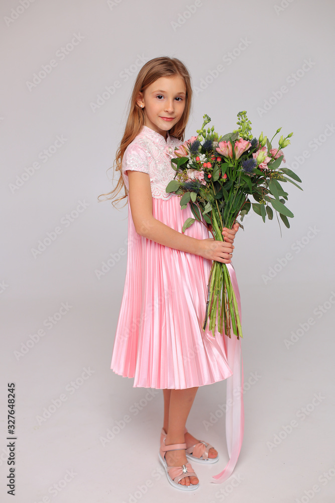 Cute little girl with flowers in her hands