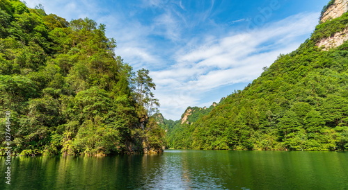 Views of a lake of calm water surrounded by dense mountains of vegetation and trees. Baofeng Lake  Bao Feng Hu  in Suoxi Valley  Wulingyuan  China