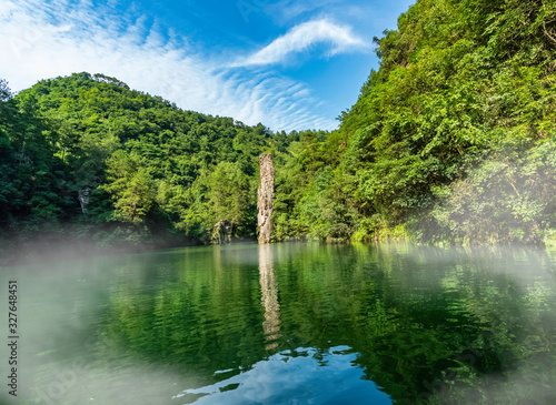 Natural column-shaped rock in the middle of the lake. Baofeng Lake in Suoxi Valley. Baofeng Lake (Bao Feng Hu) in Suoxi Valley, Wulingyuan, China