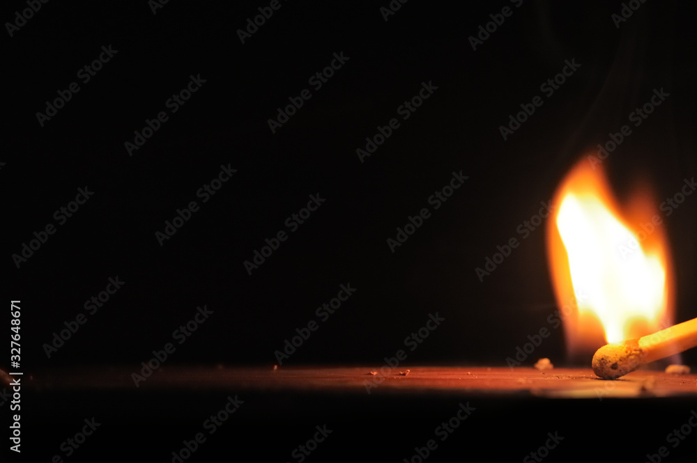 Matchstick ignites with the help of the matchbox with beautiful flames and smoke. Matchstick ignites with the help of the matchbox with beautiful flames and smoke.