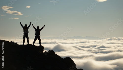 Silhouette of a man on top of mountain