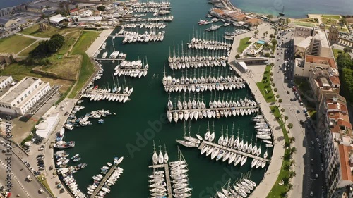 Flight over the harbour of Palermo early sunny morning. Busy traffic on the waterfront. Two kayaks floating among yachts. Sicily, Italy. May 2019. Aerial top-down shot