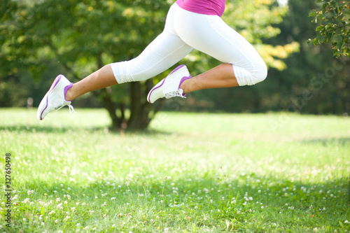 Close-up of legs: woman exercising in the nature