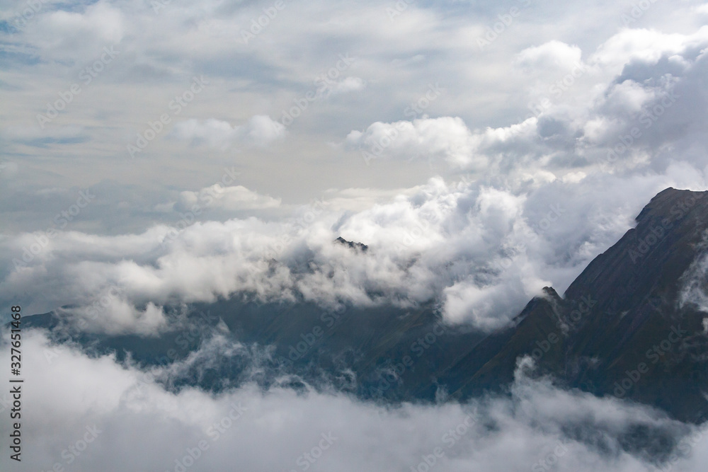 Gorgeous scenery of alpine peaks shrouded in clouds Gorgeous scenery of alpine peaks shrouded in clouds