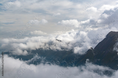 Gorgeous scenery of alpine peaks shrouded in clouds