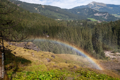 Rainbow pointing to treasure hidden in Alpine valley