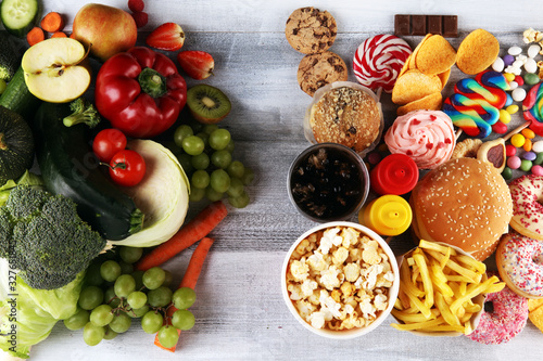 healthy or unhealthy food. Concept photo of healthy and unhealthy food. Fruits and vegetables vs donuts sweets and burgers