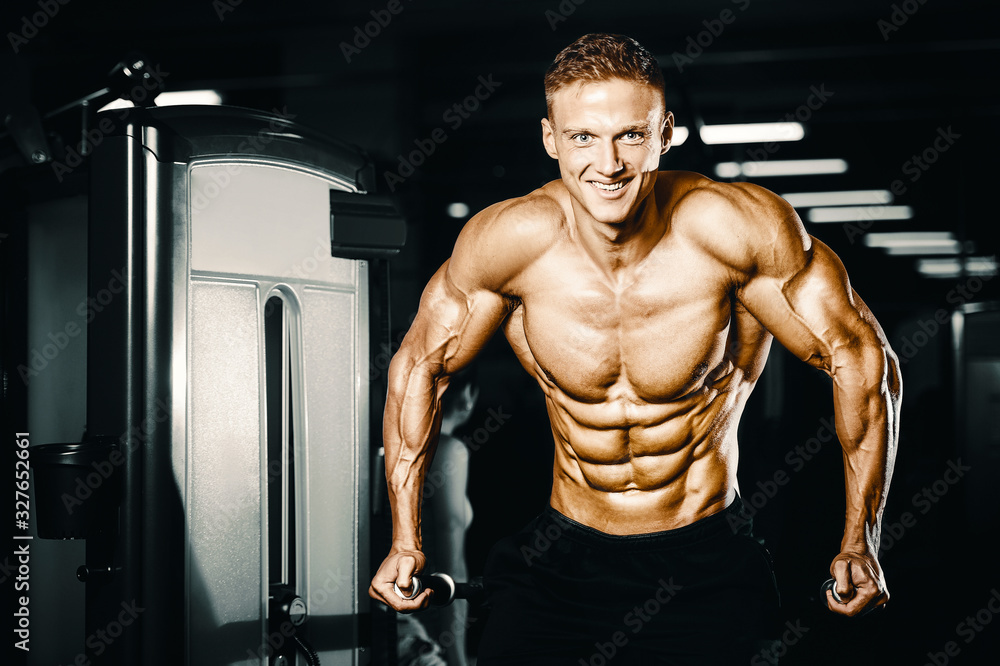 Bodybuilder pumping up chest muscles push-ups bars Bodybuilder pumping up chest muscles push-ups bars