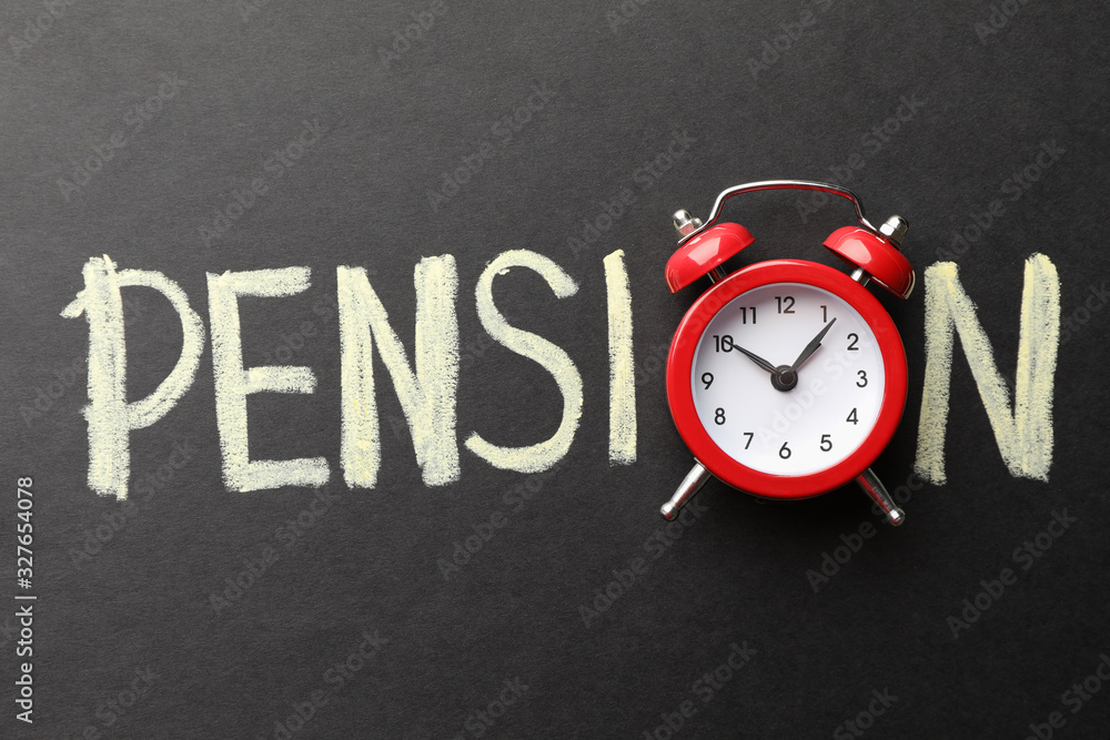 Inscription Pension with alarm clock on black background, top view Inscription Pension with alarm clock on black background, top view