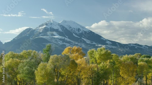 The Absaroka mountains tower above the Paradise Valley and Yellowstone river in a color filled Montana autumn photo