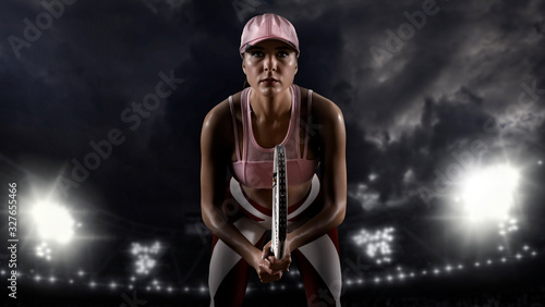 Fototapeta Naklejka Na Ścianę i Meble -  Female tennis player on dark