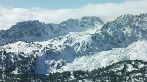 The snow covered peaks, steep cliffs and glacial valleys of the Madison mountain range in southwestern Montana photo